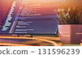 Minimal coding workspace with plant and warm lighting 131596239