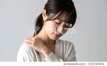 Stock image of a woman expressing stiff shoulders and fatigue Stock image of a woman expressing stiff shoulders and fatigue 131597001