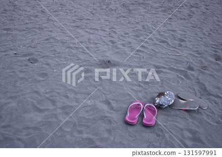 Sandals carelessly placed on the beach Sandals carelessly placed on the beach 131597991