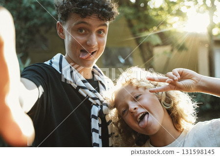 Siblings Making Funny Faces Outdoors 131598145