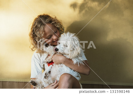 Child Hugging Fluffy Dog with Joyful Expression 131598146