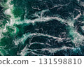 Blue waves of water of the river and the sea meet each other during high tide and low tide. 131598810