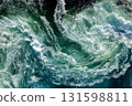 Blue waves of water of the river and the sea meet each other during high tide and low tide. 131598811