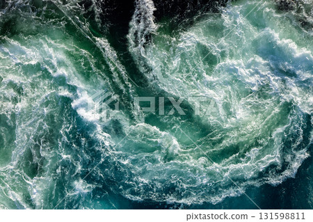 Blue waves of water of the river and the sea meet each other during high tide and low tide. 131598811