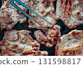 A plate of meat with spices on top. The meat is cooked and has a nice brown color 131598817