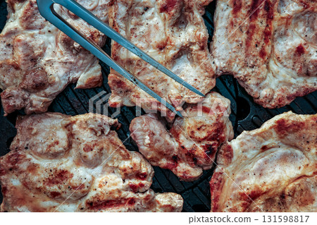 A plate of meat with spices on top. The meat is cooked and has a nice brown color 131598817