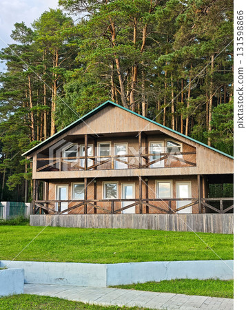 Wooden cabin by pine forest, eco lodge with balconies and green lawn Wooden cabin by pine forest, eco lodge with balconies and green lawn 131598866