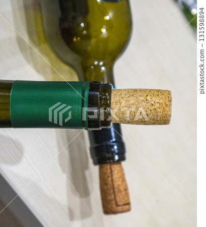 Natural cork and green glass wine bottle, craft style, Eco materials: cork and glass in winemaking, minimalism Natural cork and green glass wine bottle, craft style, Eco materials: cork and glass in winemaking, minimalism 131598894