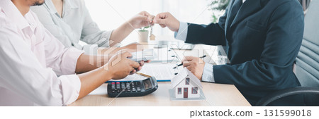 Panorama of real estate deal with house models, key handover, cash money, and calculator on desk, symbolizing property investment, mortgage loan, housing purchase, and financial planning success. Panorama of real estate deal with house models, key handover, cash money, and calculator on desk, symbolizing property investment, mortgage loan, housing purchase, and financial planning success. 131599018