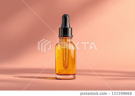 Amber glass dropper bottle with liquid on peach background 131599668