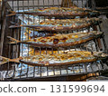 Grilling the whole saury, a taste of autumn, on a fish grill 131599694