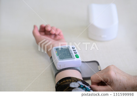 Elderly Woman Using Wrist Monitor Showing Hypertension Elderly Woman Using Wrist Monitor Showing Hypertension 131599998