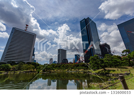 Tokyo's Kyu-Shiba Rikyu Gardens, with skyscrapers reflected in the pond and a dynamic blue sky 131600033