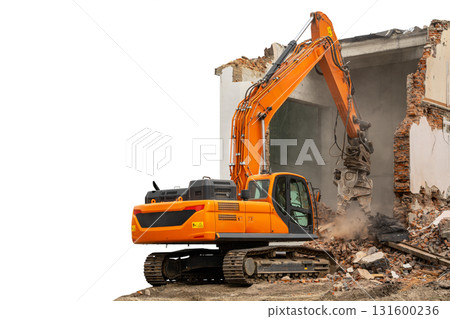 Demolition machine operating on a building's wall in an isolated construction site during daylight 131600236