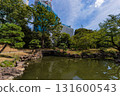 The pine trees and Japanese-style bridge at the former Shiba Rikyu Gardens in Tokyo, with a high-rise building under construction visible through the greenery The pine trees and Japanese-style bridge at the former Shiba Rikyu Gardens in Tokyo, with a high-rise building under construction visible through the greenery 131600543
