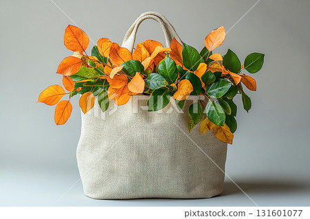 Reusable shopping bag made of fabric with a branches with yellow leaves on a white background. 131601077