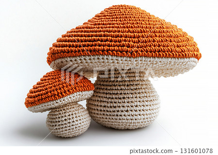 Lighting. Cozy Setup. Crocheted bright mushrooms on a white background. Autumn atmosphere. Creative hobby. 131601078
