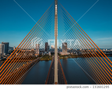Symmetric modern cable-stayed bridge over Han River in Da Nang, Contemporary urban span connecting city skyline across Vietnamese waterway 131601295