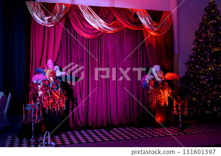 Party decor with masks, and feathers against a backdrop of purple curtains 131601397