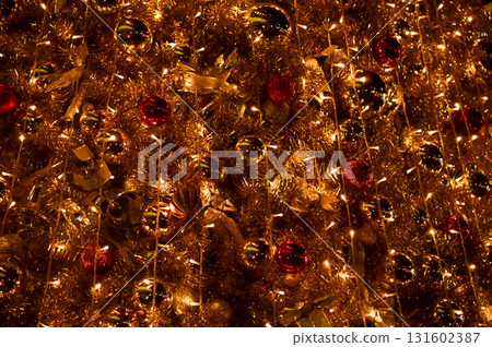 Close-up of the Christmas trees with colorful ornaments. Festive decoration. Full of ornaments. Winter season, winter festive. Christmas celebration, Xmas celebration. For background use. Close-up of the Christmas trees with colorful ornaments. Festive decoration. Full of ornaments. Winter season, winter festive. Christmas celebration, Xmas celebration. For background use. 131602387
