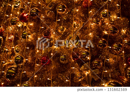 Close-up of the Christmas trees with colorful ornaments. Festive decoration. Full of ornaments. Winter season, winter festive. Christmas celebration, Xmas celebration. For background use. Close-up of the Christmas trees with colorful ornaments. Festive decoration. Full of ornaments. Winter season, winter festive. Christmas celebration, Xmas celebration. For background use. 131602389