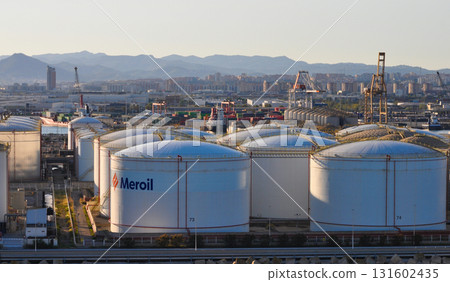 Barcelona, Spain - September 26, 2025: Meroil and Tradebe oil tanks terminal in port under sundown light at Barcelona, Spain on September 26, 2025 Barcelona, Spain - September 26, 2025: Meroil and Tradebe oil tanks terminal in port under sundown light at Barcelona, Spain on September 26, 2025 131602435