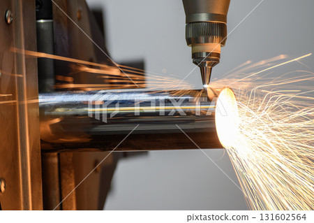Close up scene the fiber laser cutting machine cut the stainless steel tube control by CNC program. Close up scene the fiber laser cutting machine cut the stainless steel tube control by CNC program. 131602564