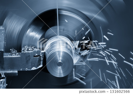 The lathe machine finish cut metal shaft parts with liquid coolant method in the light blue scene. The lathe machine finish cut metal shaft parts with liquid coolant method in the light blue scene. 131602566