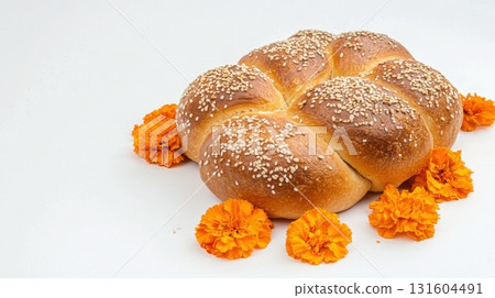 Isolated baked sweet bread with sesame seeds and festive decorations for Dia de los Muertos 131604491