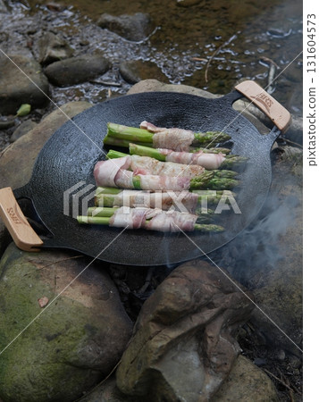 Juicy steak with asparagus on fire grill 131604573