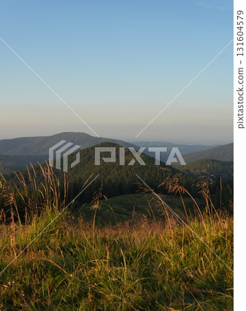 Beautiful mountain landscape, light over peaks and valleys, natural scenery, calm atmosphere and wild nature 131604579