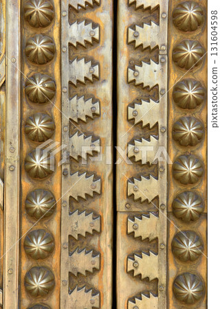 Brass doors adorned with Moroccan patterns, metal filigree, and intricate relief work. Royal Palace, Fez, Morocco Brass doors adorned with Moroccan patterns, metal filigree, and intricate relief work. Royal Palace, Fez, Morocco 131604598