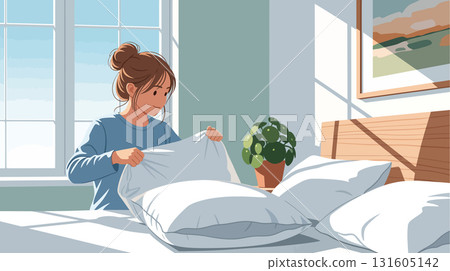 Young woman putting pillowcase on pillow 131605142