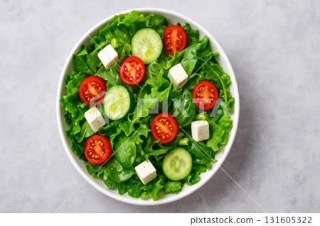 Fresh greek salad with feta, tomatoes, and cucumbers in white bowl 131605322