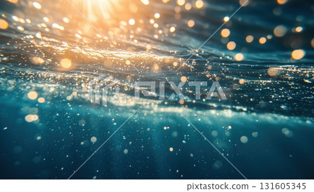 Light Streaming Through The Water In The Breathtaking Underwater Scene Of Bubbles And Ocean Surface 131605345