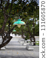 Green lamp hanging in a quiet park walkway 131605870