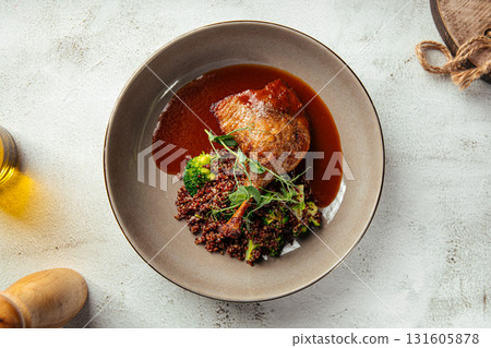 Grilled duck leg with quinoa and green vegetables Grilled duck leg with quinoa and green vegetables 131605878