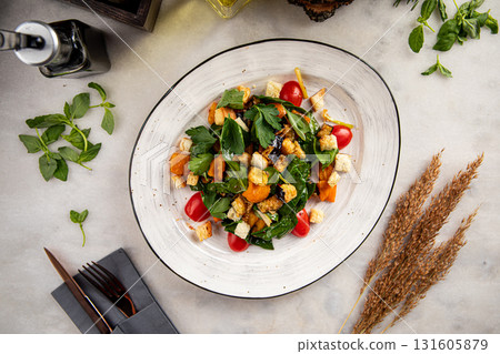Salad with fried aubergine, tomatoes and croutons Salad with fried aubergine, tomatoes and croutons 131605879