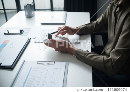 Businessman reading report in office desk analyze data for plan project Businessman reading report in office desk analyze data for plan project 131606074
