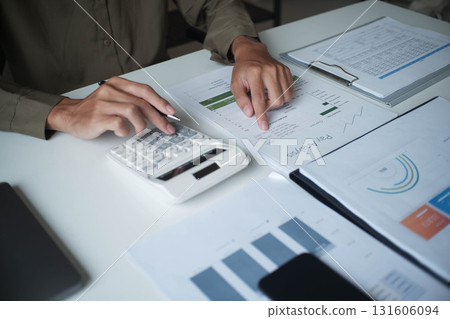 Businesswoman, entrepreneur, accountant working on financial report on desk using calculator. Businesswoman, entrepreneur, accountant working on financial report on desk using calculator. 131606094