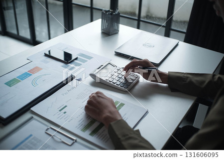 Businesswoman, entrepreneur, accountant working on financial report on desk using calculator. Businesswoman, entrepreneur, accountant working on financial report on desk using calculator. 131606095