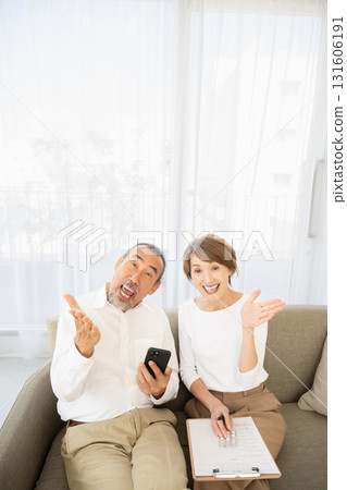 An active senior couple recommending a smartphone 131606191
