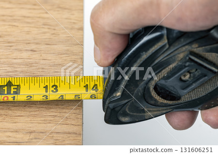 Hand holding measuring tape wood carpenter measure closeup tool yellow inch workshop. Precise measurement oak board steady grip practical and focused mood for carpentry and home repair projects Hand holding measuring tape wood carpenter measure closeup tool yellow inch workshop. Precise measurement oak board steady grip practical and focused mood for carpentry and home repair projects 131606251