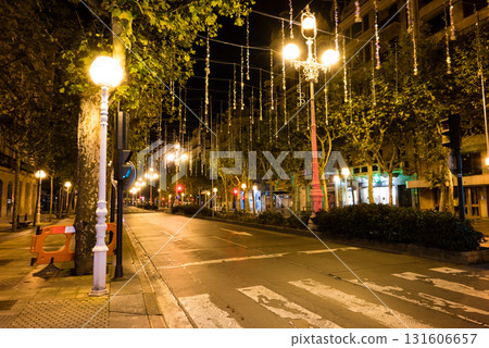The empty streets of San Sebastian, lined with street lamps decorated for Christmas in the early morning 131606657