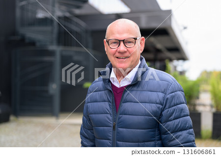 Portrait of a smiling senior man with eyeglasses in the city 131606861