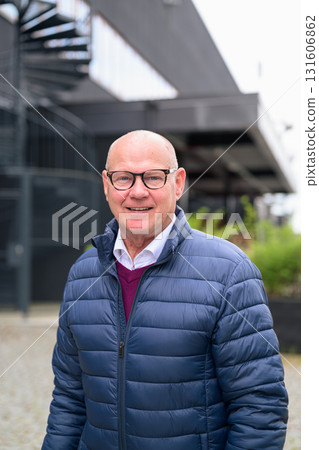 Portrait of a smiling senior man with eyeglasses in the city Portrait of a smiling senior man with eyeglasses in the city 131606862
