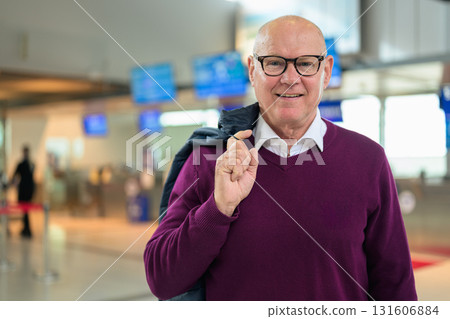Portrait of a smiling senior man at the airport wearing glasses 131606884