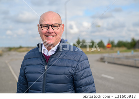 Portrait of a happy senior man with eyeglasses smiling outdoors 131606918