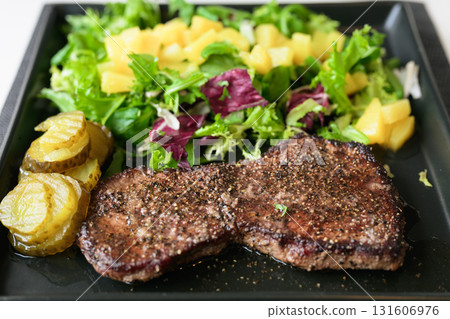 Healthy steak and salad meal on table at home Healthy steak and salad meal on table at home 131606976