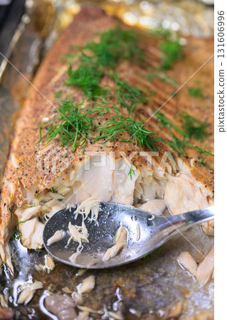 Smoked salmon with dill on a baking sheet, selective focus Smoked salmon with dill on a baking sheet, selective focus 131606996